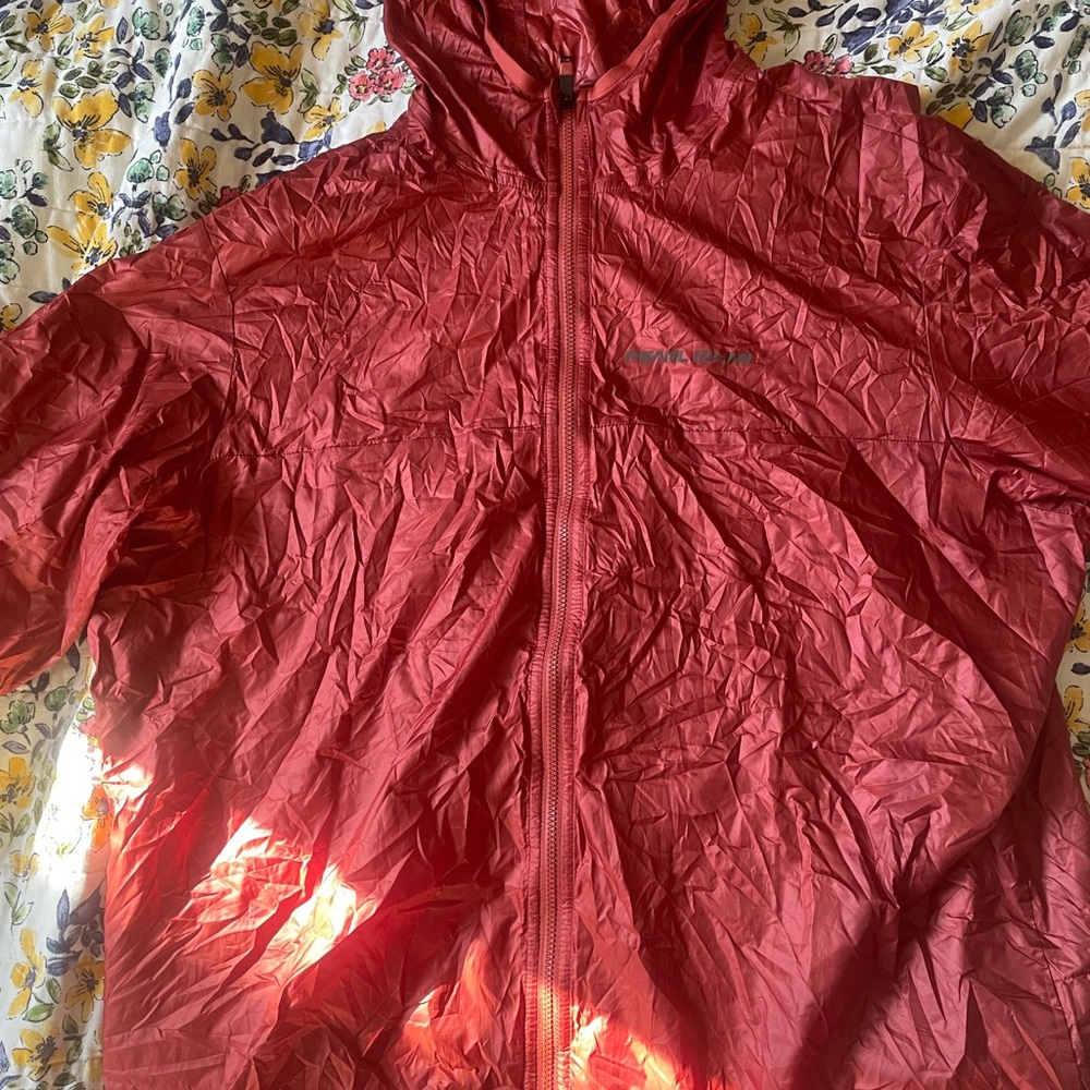 Pearl Izumi wind/light rain layer. Never worn. Beautiful rust color. New model.